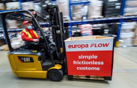 Man driving forklift carrying Europa Flow box