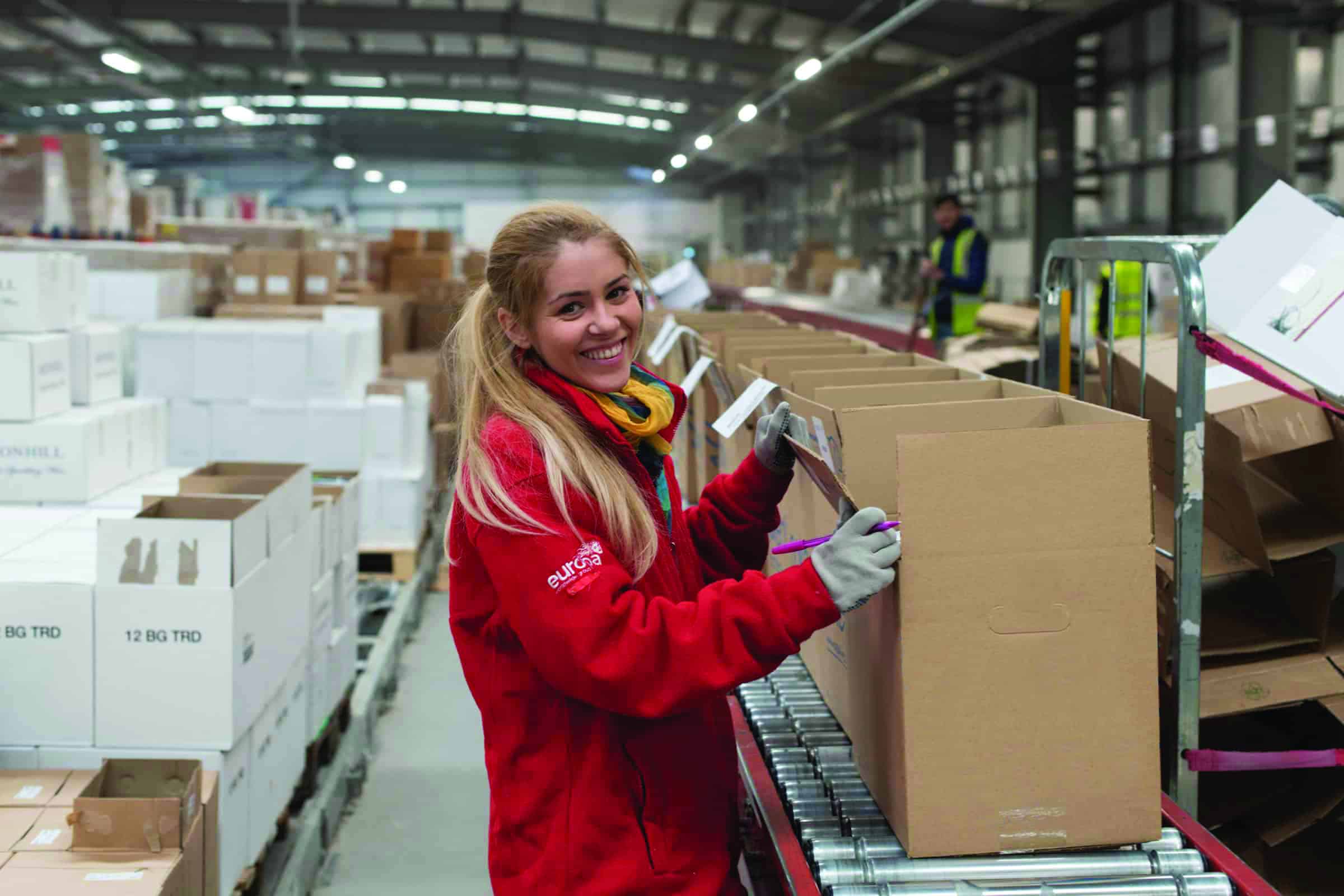 Europa Warehouse team member holds boxes in one of its 3pl warehouses